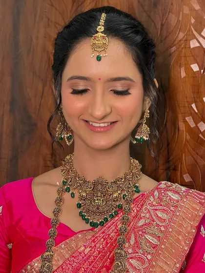 My bride Dhwani needed just a touch of enhancement. The result was a dreamy look with fresh skin, soft eyes, and a perfect traditional finish.