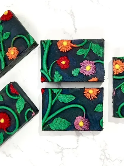 My entry for a silicone mat impression challenge, titled "In Darkness We Bloom." I sculpted the floral design myself, made a silicone mat from it, and poured the soap.