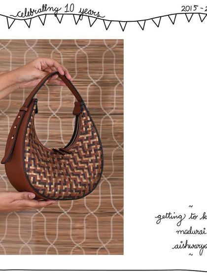 A side view of the Madurai Aishwarya, highlighting its firm, structured shape and adjustable shoulder handle.