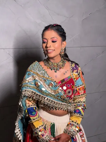 A close-up of the Navratri makeup, featuring a vibrant pink eyeshadow and a small bindi, perfectly complementing the colorful chaniya choli.