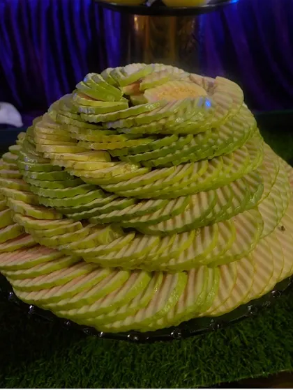 An artfully arranged platter of thinly sliced melon, showcasing our skill in fruit carving and presentation.