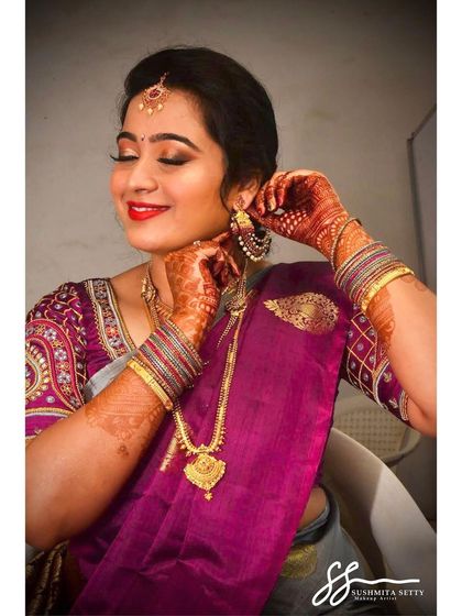 A lovely shot of the bride adjusting her earrings. The makeup is designed to last all day, looking fresh and flawless through every moment of the celebration.