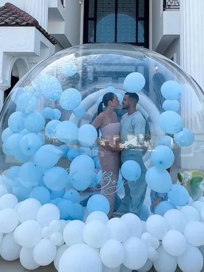 The big reveal! My bubble house gender reveal is a unique way to share your news. Here, the parents-to-be are about to discover they're having a boy as they step into a transparent dome filled with blue balloons.
