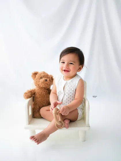 Sitting pretty in his little chair with a teddy bear companion. A simple and sweet baby portrait.