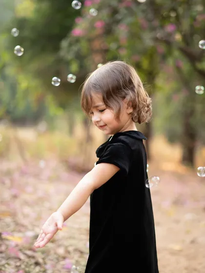 The simple joy of chasing bubbles in a beautiful garden. I use activities like this to bring out natural smiles and capture the carefree spirit of childhood during my outdoor toddler photoshoots.