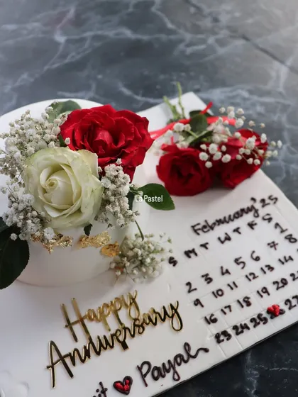 The perfect combination of a personalized cake and a bouquet of fresh roses for an anniversary.