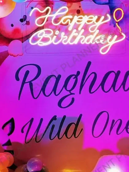 A detailed shot of the "Wild One" neon sign and balloon arrangement.