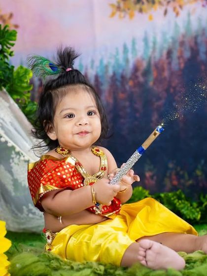 The sweetest smile from our little Krishna. This shot captures a moment of pure joy and innocence during a traditional themed photoshoot.