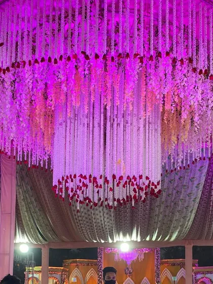 A detailed shot of the intricate flower and fabric work on the large hanging chandelier.
