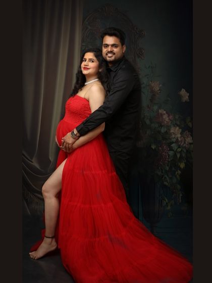 Painting the town red and embracing the glow. A glamorous couple portrait that captures the confidence and joy of the parents-to-be.