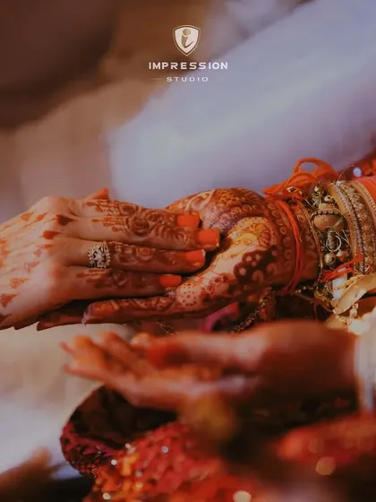 Candid moments, genuine smiles. A close-up on the couple's hands during a wedding ritual, a powerful symbol of their union.