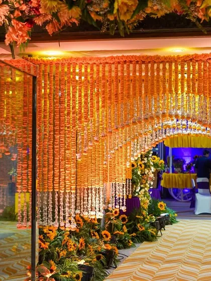 The entrance to the marigold tunnel, framed by large, lush floral arrangements. This shot shows how the tunnel is integrated into the overall decor scheme.
