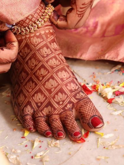 A close-up of the stained lotus grid pattern on the foot. The rich color looks beautiful against the skin and the colorful flower petals.