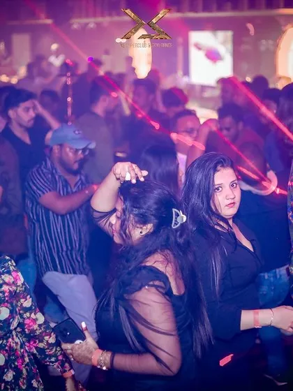 The dance floor at XS Superclub under the glow of red laser beams.