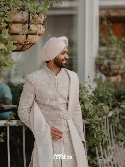 A candid shot of the groom, Gurpreet, looking relaxed and happy on his wedding day.