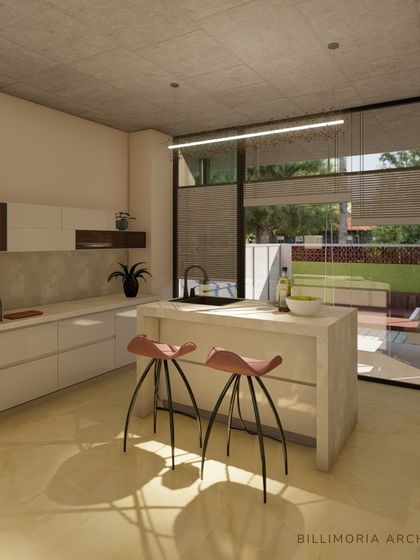 A bright and modern kitchen with a central island and pink bar stools. The design takes advantage of a large window overlooking the garden, making the kitchen a pleasant and light-filled space to be in.