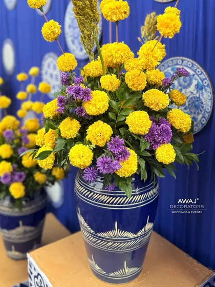 A lush arrangement of marigolds and statice, bringing a pop of color and traditional fragrance to the celebration.