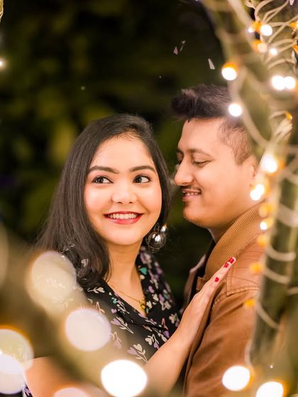 A close-up shot that captures the intimacy of a couple's moment, with the soft bokeh of the fairy lights adding to the romance.