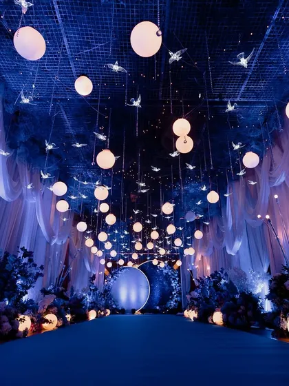 For this Sangeet, we turned the ballroom into a celestial dream. With deep blue lights and a ceiling full of stars, it was a night where love felt written in the cosmos.