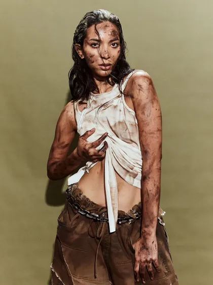 A simple white tank top and trousers are transformed with distressing and texture for the Huemn runway.