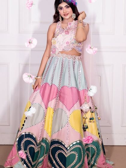 Another view of the heart-patterned lehenga, showing the mirror work and vibrant colors.