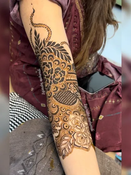 A detailed shot of the upper arm band, featuring a beautiful blend of floral and leaf motifs.