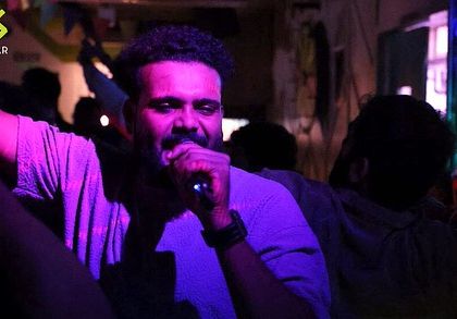 A guest takes over the mic during our New Year's party, adding to the celebratory atmosphere.