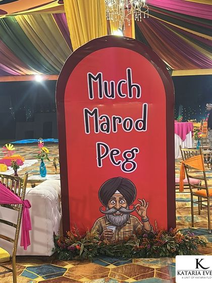 To add a touch of local Punjabi humor to the party, I created this custom 'Much Marod Peg' sign. It's a fun prop that encourages guests to enjoy themselves and becomes a popular spot for photos during the Sangeet or cocktail night.