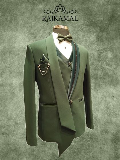 A different view of the unique olive green tuxedo, showcasing its unconventional draped lapel that adds a high-fashion element to a traditional formal wear piece.