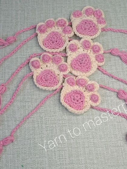 A closer look at the crochet paw print rakhis. I make these with soft cotton yarn so they are comfortable to wear all day.