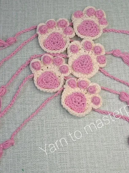A closer look at the crochet paw print rakhis. I make these with soft cotton yarn so they are comfortable to wear all day.