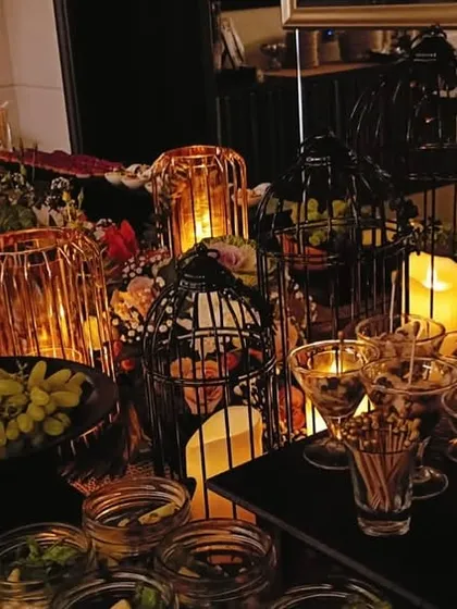 About last night. A glimpse of a dreamy, candlelit buffet filled with grapes, nuts, desserts, and savory bites.
