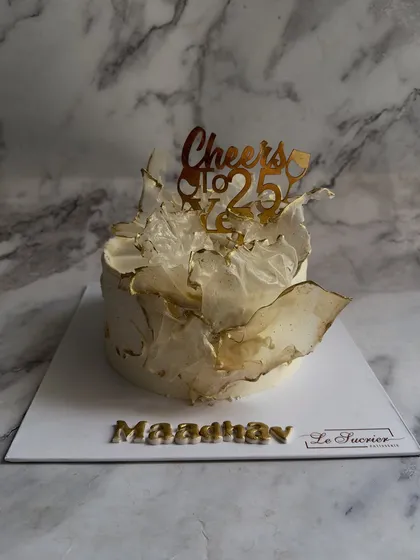 Modern elegance crafted for a 25th birthday. This cake features delicate, edible wafer paper sails with hand-painted gold edges, creating a contemporary and artistic statement piece.