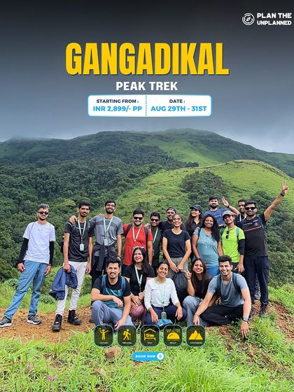A happy group of trekkers at the summit of Gangadikal Peak. This trek offers stunning panoramic views of the surrounding Western Ghats.