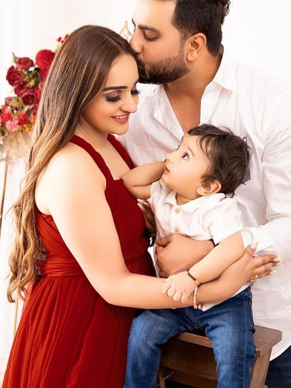 A loving family of three. The baby's curious upward gaze towards his parents makes this an especially precious and candid moment.