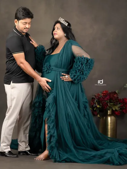 A regal pose showing the dad-to-be's protective hand on the baby bump. The tiara and flowing gown make the mom-to-be look and feel like royalty.