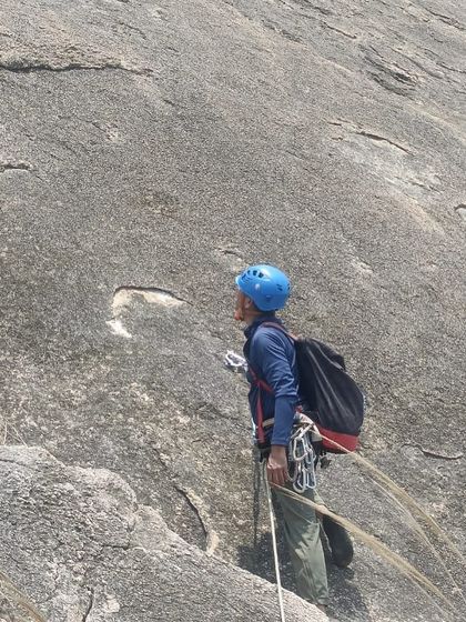 A climber prepares to rappel after a long multi pitch climb. Mastering technical skills like this is crucial for big wall adventures.