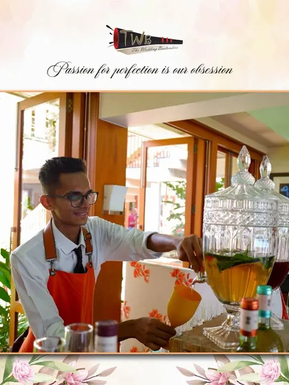 A bartender serves from a beverage dispenser at a sunny Alibag brunch, ensuring quick and refreshing service.