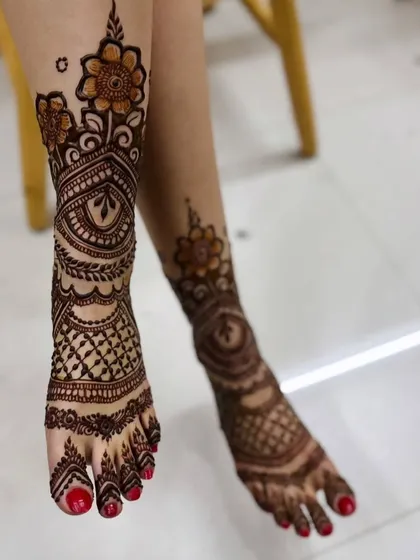 A stylish foot design with a floral vine climbing up the side of the leg, combined with a dense pattern on the foot itself.