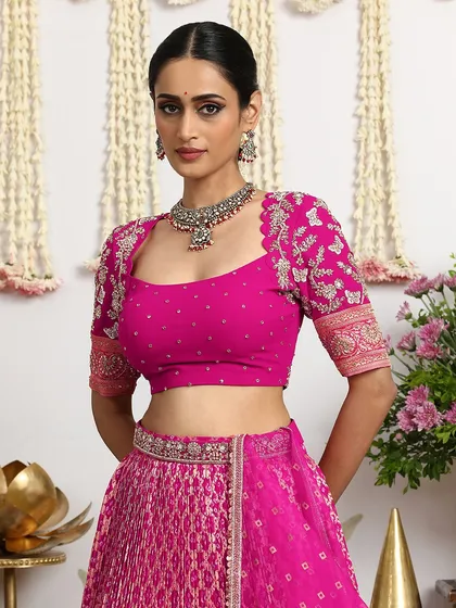 A close-up view of the intricately embroidered blouse, featuring delicate butterfly motifs and a scalloped neckline. This piece showcases the fine craftsmanship that defines our bridal couture.