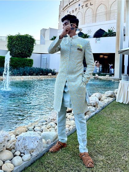 A mint green sherwani designed for the brother of the groom at a destination wedding in Bahrain. The fresh color and sharp tailoring make for a standout look.