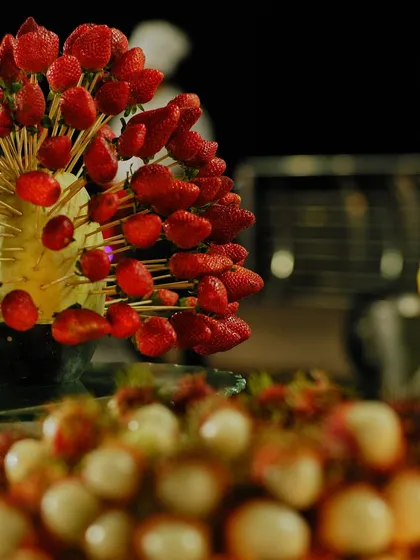 An artistic display of fresh strawberries on skewers. Our fruit displays are designed to be both a healthy dessert option and a beautiful centerpiece.