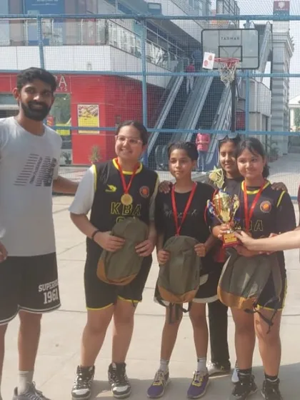 Our Under-14 girls team celebrating their win at the 3x3 Decathlon tournament. They played with skill and determination to earn this trophy.