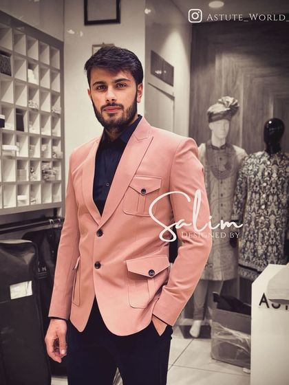A client wearing a pink blazer with safari-style pockets. This is a modern, stylish jacket that adds a pop of color to any wardrobe.