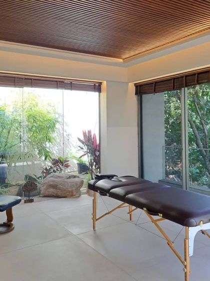 We created a dedicated spa and massage room in this "House in the Hills." A large glass window looks out onto a tranquil garden with natural rocks, bringing the calming elements of nature into this space of relaxation.
