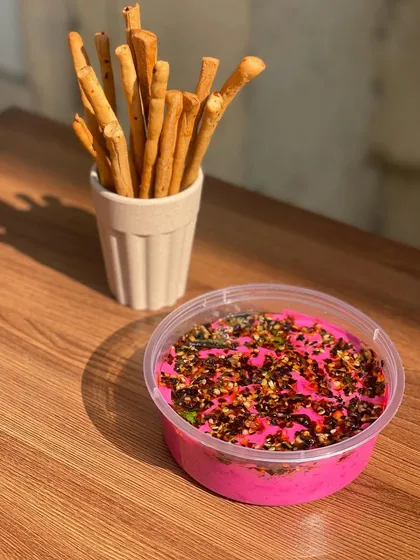My vibrant beetroot hummus, topped with a flavourful seed mix. It's delicious when paired with my freshly baked breadsticks or herb crostinis.