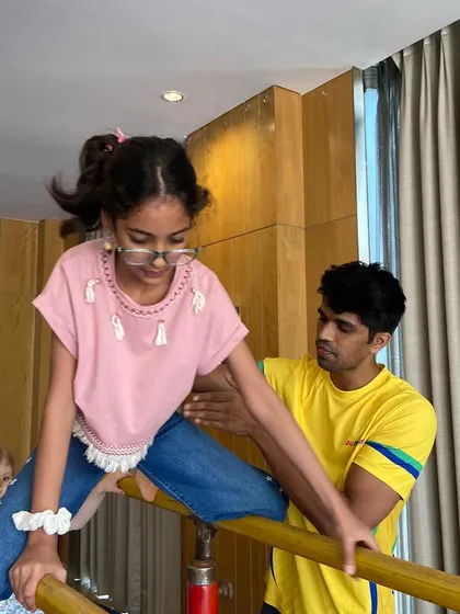 A young gymnast gets some pointers from our coach on the parallel bars. We tailor our instruction to each child's skill level, from beginner to advanced.