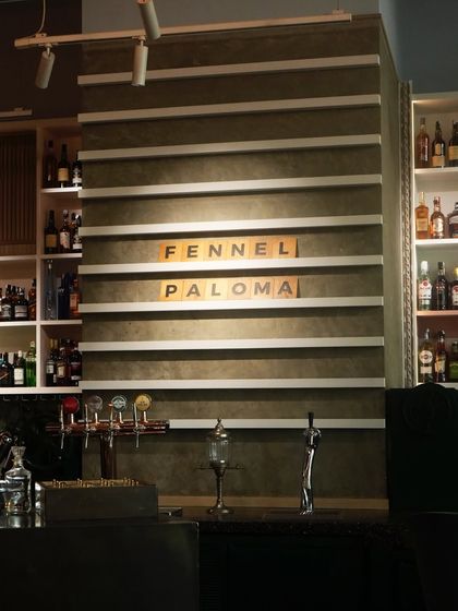 Behind the bar, our letter board announces the Fennel Paloma, a signature creation featuring citrus, spice, and a whisper of fennel.