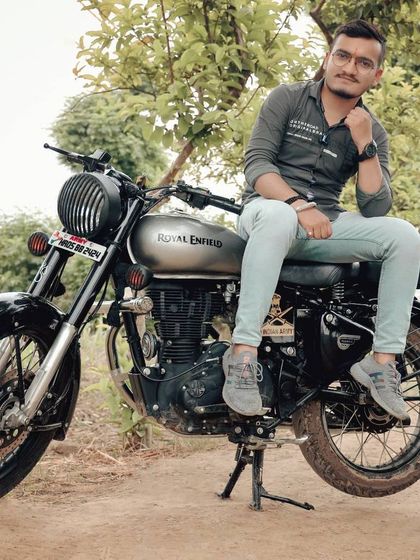 An outdoor portrait session featuring a Royal Enfield in a rustic, natural setting. These shoots are perfect for couples who love adventure and the outdoors.