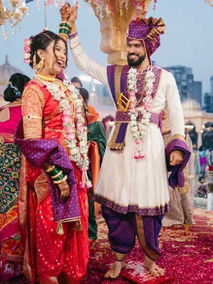 A celebratory moment right after the main rituals, showcasing the couple's happiness and traditional Marathi wedding attire.